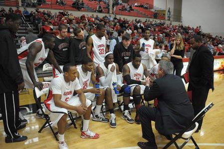 Coach David Niven talks to players in the final moments of their game against Bethel University, which the Bulldogs won by only one shot, 77-75.   - Photo by Morris Abernathy