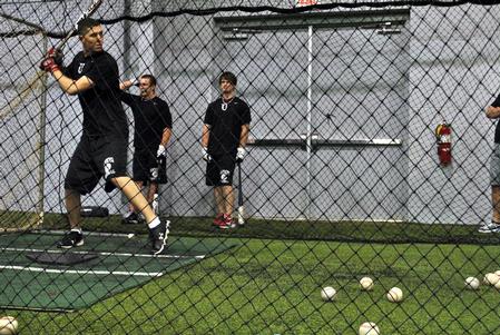 The baseball team practices their hitting in the Fesmire Field House.  - Photo by Victoria Stargel