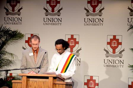 Zachary Pendergrass, coordinator of career planning and development, reads a Bible verse in English as Mikias Seid, senior intercultural studies and computer science major, reads the same verse in Amharic at the 4th Annual Black History Month Program. - Photo by Deanna Santangelo