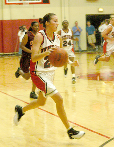 Peggy McCain (21), a sophomore guard for Union, hurries the ball down the floor.  Union players Monica Elliot (24) and Molly York (34) follow.  - Photo by Courtney Ross