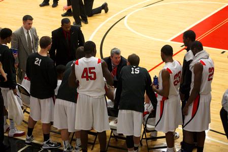 Bulldogs head coach, David Niven, pumps up his players during a timeout. The Bulldogs won the game against Bethel University 77-75.  - Photo by Ebbie Davis