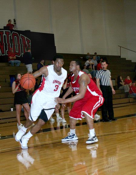 CJ Davis runs the ball down the court during the game against Lyon College. - Photo by Deanna Santangelo