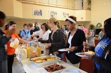 Students fill their plates at the Presidents Day welcome back breakfast, sponsored by Residence Life. - Photo by Abigail Harris