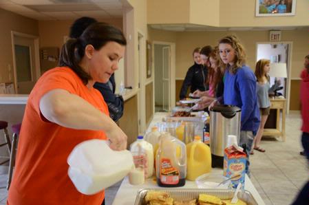 Ashley Jackson, resident director of the Heritage Complex, serves students during the President's Day welcome back breakfast.  - Photo by Abigail Harris