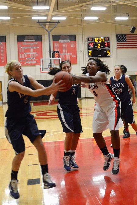 Hope Adams fights for the rebound against her Lyon College opponents.  - Photo by Beth Spain