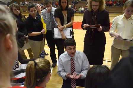 Mark Campbell, head women's basketball coach, gives an encouraging talk to the players. - Photo by Beth Spain
