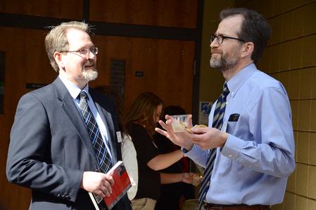 Dr. John Netland, professor of English and Department Chair, and Bobby Rogers, professor of English, discuss the reading by guest writer Lorraine Lopez while enjoying refreshments. - Photo by Abigail Harris