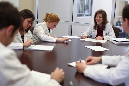 Kimberly Lindsey, assistant professor of pharmacy practice, meets with pharmacy students in Providence Hall.  - Photo by Kristi McMurry Woody