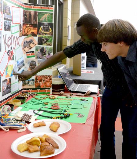 Alex Kipchirchir, junior computer science major, talks about the culture in Kenya to Georg Pingen, assistant professor of engineering, during CultureFest 2011 in the Student Union Building.
 - Photo by Deanna Santangelo