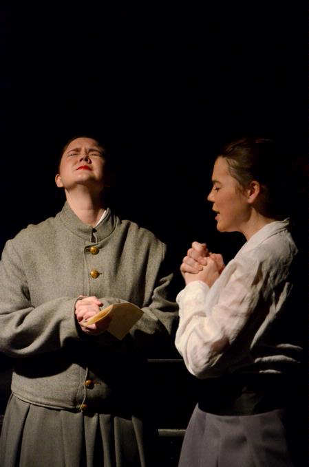 Heather Nicholas, junior theatre and speech major, prays with Natalie Schklar, freshman social work major in the theater department's production of "The Winter's Tale," in the W.D. Powell Theatre.  - Photo by Deanna Santangelo