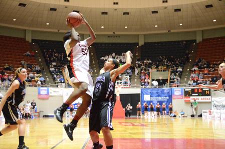 Lavanda Ross shoots high above a block attempt by her Avila University opponent during the first game of the NAIA National Championship.  - Photo by Abigail Harris