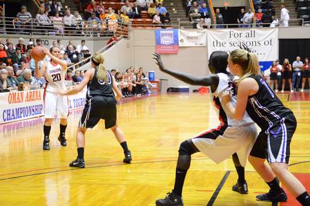 Kayla Hudson looks to pass the ball to Zeinab Chan under the basket during the first game of the NAIA National Championship. - Photo by Abigail Harris
