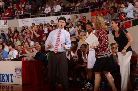 Mark Campbell, head coach, and Katie Woodruff, assistant coach, talk on the sidelines during game two of the NAIA National Championship. - Photo by Morris Abernathy