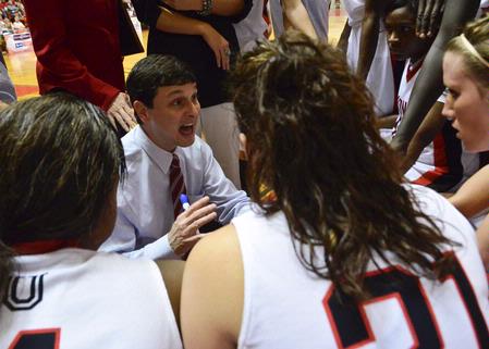 Mark Campbell, head coach, talks to the Lady Bulldogs during a time-out in the semifinals game of the NAIA National Championship. - Photo by Beth Spain