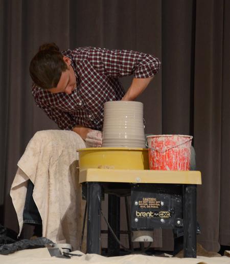 Zac Benson, art major, forms a clay pot as Nigel Goodwin, founder of Genesis Arts Trust, challenges Union students to submit to the molding hand of the Master Potter. - Photo by Victoria Stargel