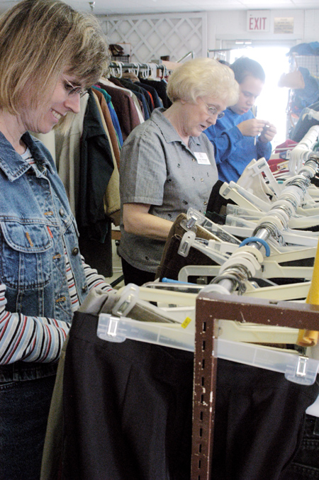 Union staff members Robin Navel and Elsie Cressman work at RIFA sorting clothing on the Day of Remembrance. - Photo by Lindsay Stavish