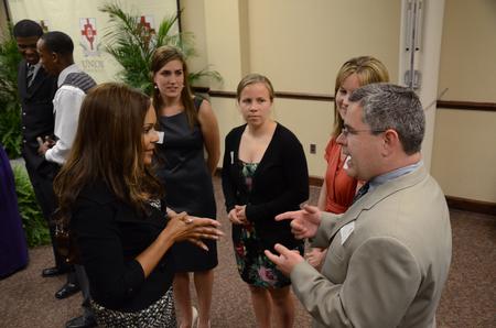 Lauren Dungy talks with Brandon Boylan, women's soccer coach, and students before the Roy L. White Golf and Gala event. - Photo by Abigail Harris