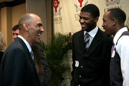 Tony Dungy, Super Bowl winning coach, greets Antoine Hall, junior DMS major, and Skyler Vaden, junior sports management major, during the Roy L. White Golf and Gala. - Photo by Deanna Santangelo