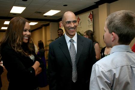 Tony and Lauren Dungy, super bowl winning coach and his wife, greet Michael Elliott, son of Kelly Elliott, during the Roy L. White Legacy Golf and Gala. - Photo by Deanna Santangelo