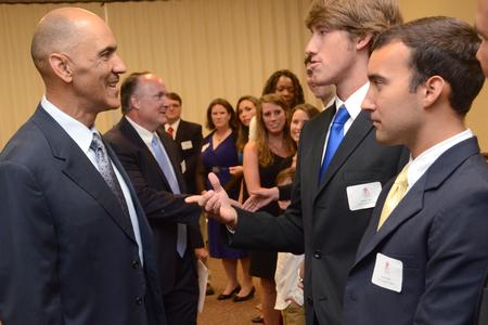 Tony Dungy, the first African American coach to lead an NFL team to Super Bowl victory, greets Jacob Long, sophomore athletic training major, during the Roy L. White Golf and Gala.  - Photo by Beth Spain