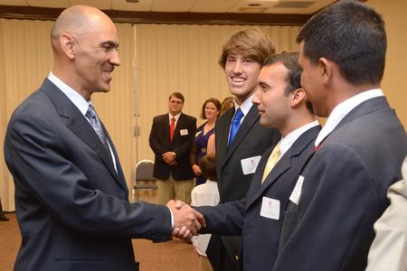 Tony Dungy, the first African American coach to lead an NFL team to Super Bowl victory, greets Luke Foshee, junior biology major, during the Roy L. White Golf and Gala.  - Photo by Beth Spain