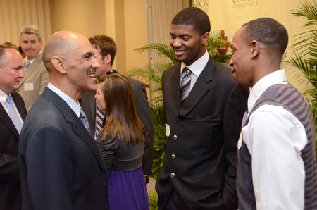 Tony Dungy, Super Bowl winning coach, greets Antoine Hall and Skyler Vaden during the Roy L. White Golf and Gala.  - Photo by Beth Spain