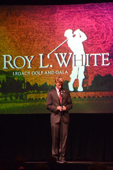 Karl Magnuson, junior SGA president, gives the opening prayer at the Roy L. White Golf and Gala. - Photo by Beth Spain