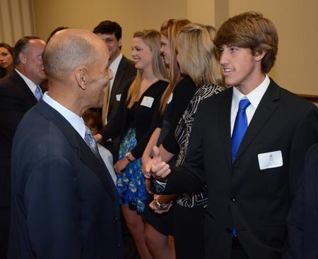 Union soccer player, Jacob Long, meets Super Bowl winning coach, Tony Dungy, who was the keynote speaker at Union's annual Roy L. White Golf and Gala. - Photo by Ebbie Davis