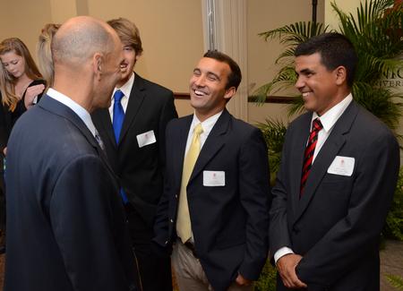 Tony Dungy, Super Bowl winning coach, greets Luke Foshee, junior biology major, at the meet and greet part of the Roy L. White Golf and Gala.  - Photo by Ebbie Davis