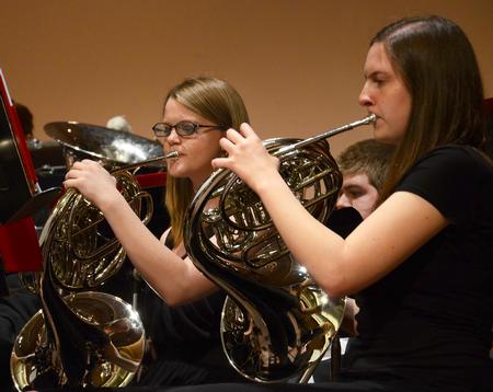 Rebecca Henderson, sophomore music education major, and Betsy Olson, junior physics major, play the french horn as the Union University Symphonic Band gives their Spring Concert in the Savage Memorial Chapel.  - Photo by Victoria Stargel