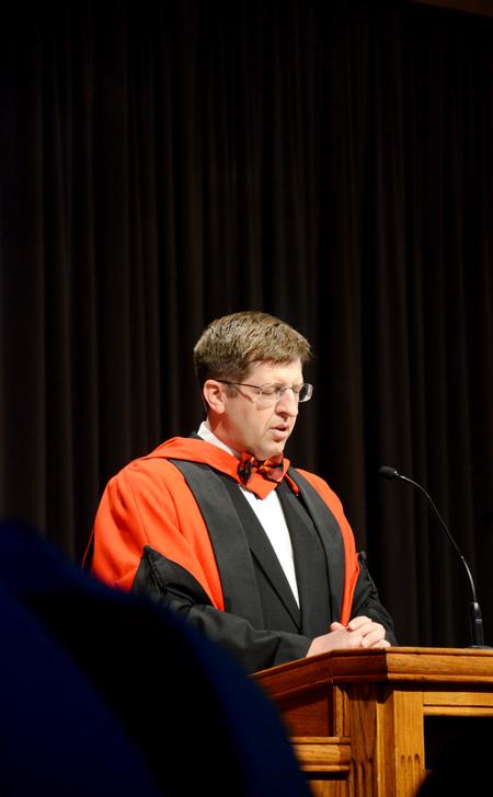 Ray Van Neste, associate professor of Biblical studies, prays at the beginning of Awards Day chapel. - Photo by Deanna Santangelo