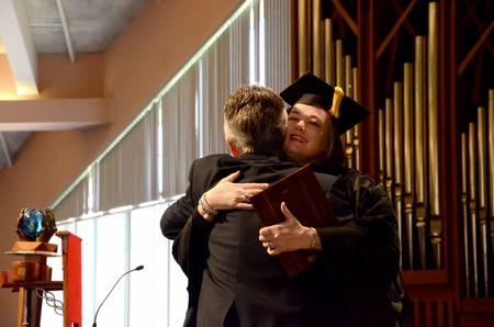 Robert Graves, vice president for undergraduate admissions, receives the Staff Member of the Year Award from Carla Sanderson, provost and executive vice president, during Awards Day chapel. - Photo by Deanna Santangelo
