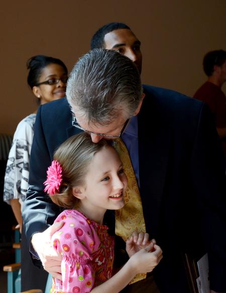 Robert Graves, vice president for undergraduate admissions and the recipient of the Staff Member of the Year Award, hugs his daughter during Awards Day chapel. - Photo by Deanna Santangelo