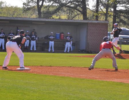 Derek Roof turns and throws to first baseman Kevin Kirksey (9) to pick off a runner. - Photo by Uncredited