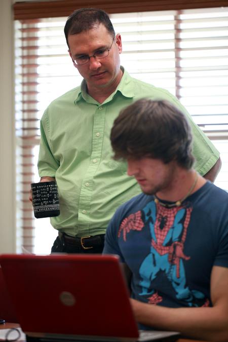 Michael Salazar, associate professor of chemistry, looks over some P.Chem calculations with Tyler Hardee, junior chemistry major. - Photo by Kristi McMurry Woody