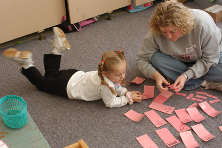 Sophomore Kristen Lutrell, learning foundations major, makes flashcards with a student at Parkview Motessori during Day of Remembrance 2003. - Photo by Jonathan Blair