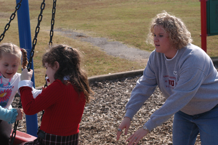 Sophomore Learning Foundations major Kristen Lutrell takes recess with some children during Day of Remembrance 2003. - Photo by Jonathan Blair