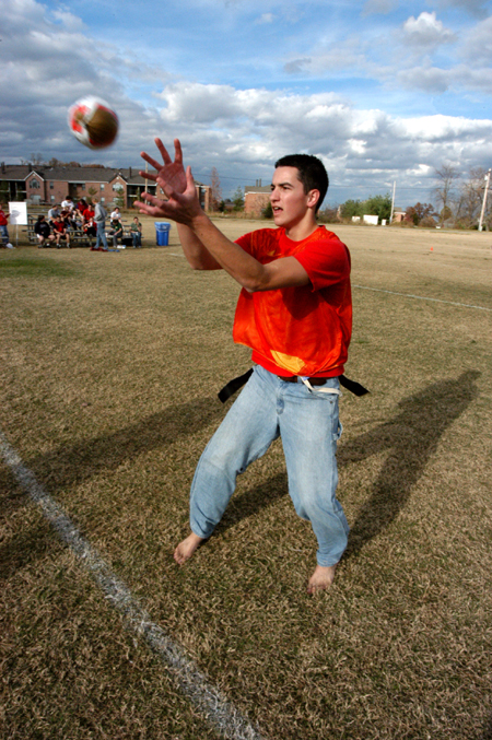 Sophomore Aaron Perry, sports medicine major, receives the hiked turkey from the center during the First Annual Turkey Bowl. - Photo by Jonathan Blair