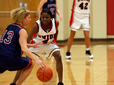 Union sophomore guard, Latorya Fuller (4) defends against a Lyon College Piper ball handler. - Photo by Jonathan Blair