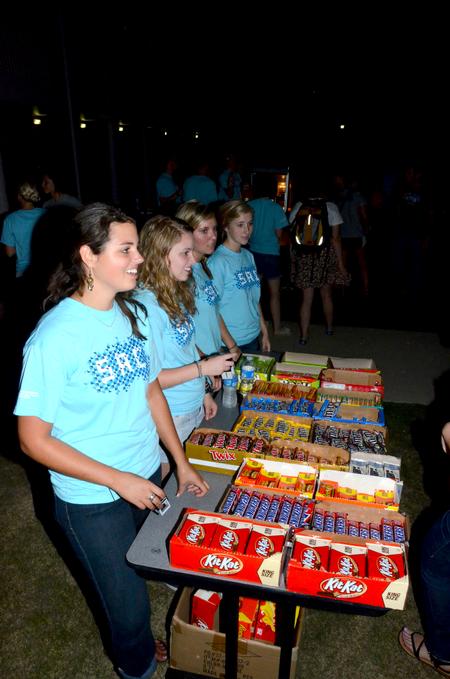 Ruth Minor, senior nursing major, serves candy at the Movie on the Lawn, hosted by Student Activities Council. - Photo by Ebbie Davis