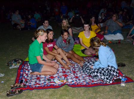 Students share a laugh during Movie on the Lawn, hosted by SAC.  - Photo by Ebbie Davis