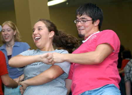 Freshman Jacob Shatzer, theology major, shares a laugh with his partner, freshman Katie Daniels, as they practice dipping at an educational class on swing dancing during Swing Nite. - Photo by Jonathan Blair