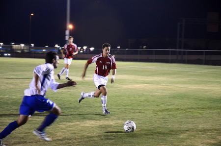 Cody Styx, sophomore business administration and management major, races a Notre Dame College opponent to the ball.    - Photo by Zac Calvert