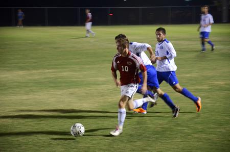 Sutton Shults dribbles the ball through Notre Dame College's defensive line during a soccer game at Union.   - Photo by Zac Calvert