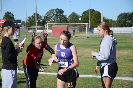 Cross country runners Audrey Hazlehurst, Lilli Harmon, and Whitney Sweet help high school runners in a race at Union.  - Photo by Zac Calvert