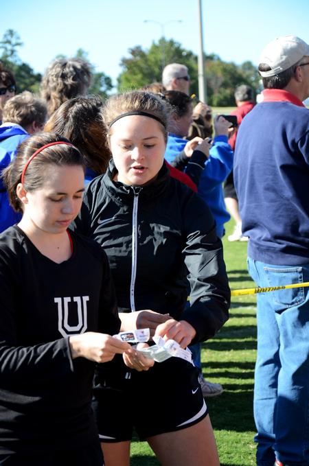 Cross country runners Cally Howell and Allison Martin help out at a high school meet on Union's campus. - Photo by Zac Calvert
