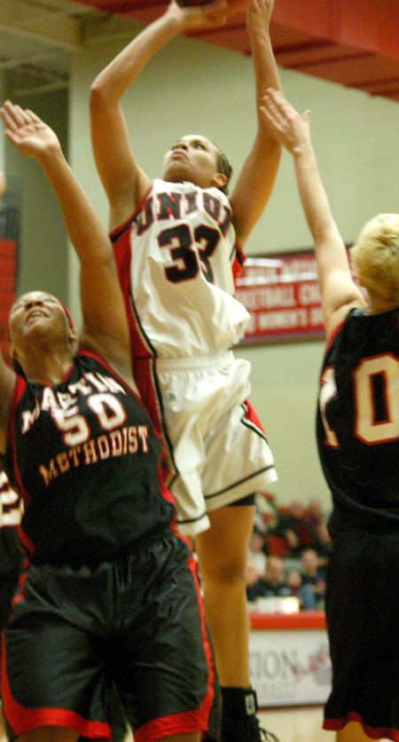 Junior forward Stephanie Clark takes a shot over severall Martin Methodist defenders.  Clark leads Union in scoring and rebounding. - Photo by Steven Aldridge