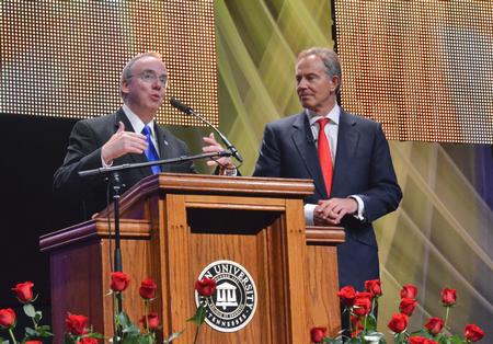 David S. Dockery, president of the university, asks Tony Blair, former British Prime Minister, several questions at the Scholarship Banquet. - Photo by Morris Abernathy