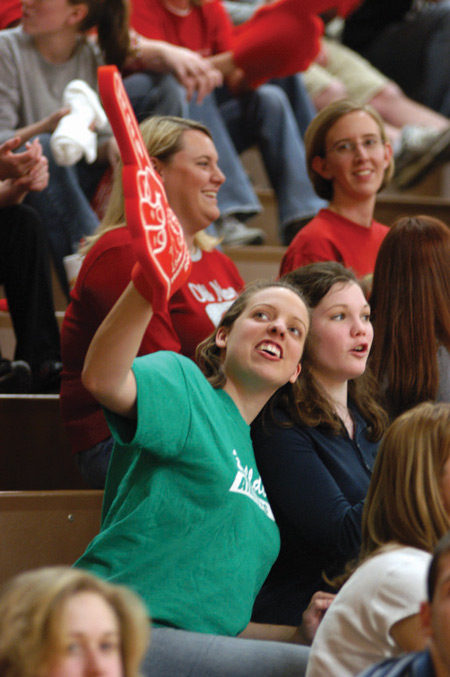 Junior Sara Orr, theatre major, checks the score of the Lady Bulldogs game as it nears the end. - Photo by Jim Veneman