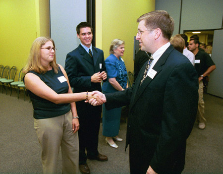 Senior Class Treasurer Amy Edge (left) and Senior Class President Casey Stafford (center) greet Director of the R.C. Ryan Center for Biblical Studies, Ray Van Neste at the President's Reception. - Photo by Jim Veneman